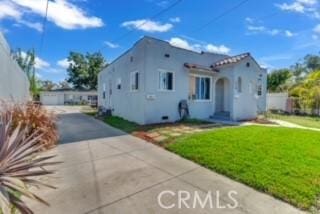 234 E Raymond St, Compton, CA 90220 - view of front of property featuring a front lawn, driveway, and stucco siding