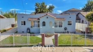 234 E Raymond St, Compton, CA 90220 - mediterranean / spanish home featuring a fenced front yard and stucco siding