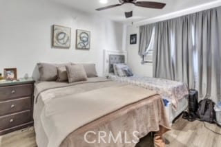 bedroom with light hardwood / wood-style flooring and ceiling fan