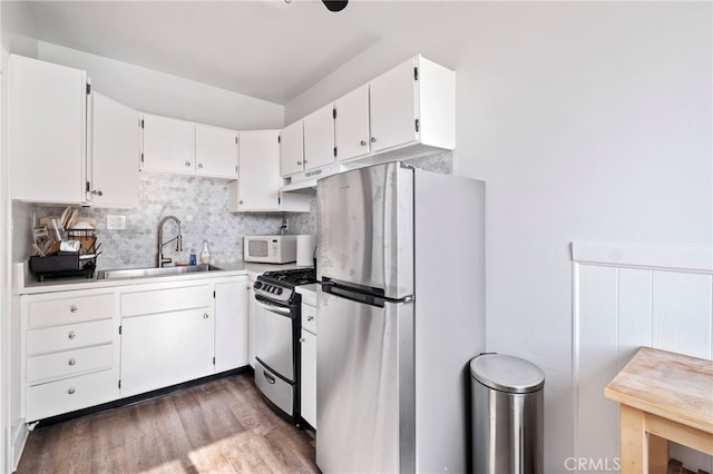 kitchen featuring white cabinets, stainless steel appliances, dark hardwood / wood-style floors, and sink