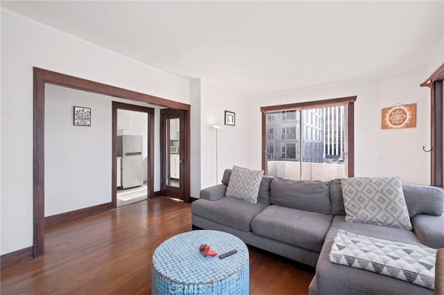 living room with ornamental molding and dark wood-type flooring