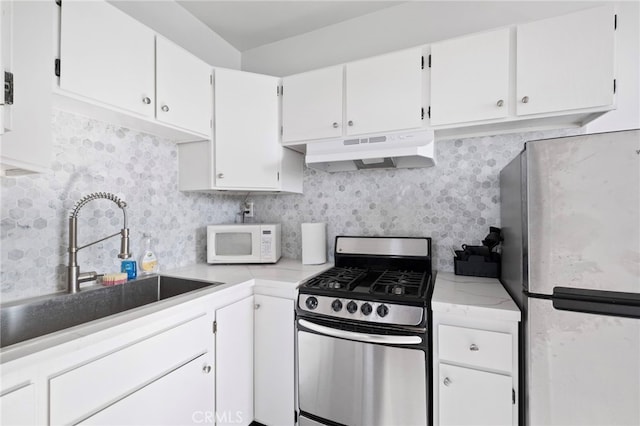 kitchen with white cabinetry, sink, and stainless steel appliances