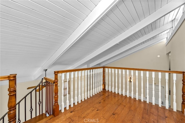 hall with vaulted ceiling with beams, hardwood / wood-style flooring, and wood ceiling