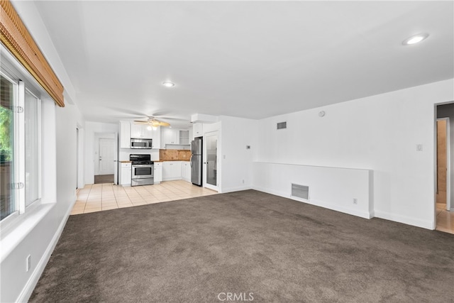 unfurnished living room with light carpet and ceiling fan