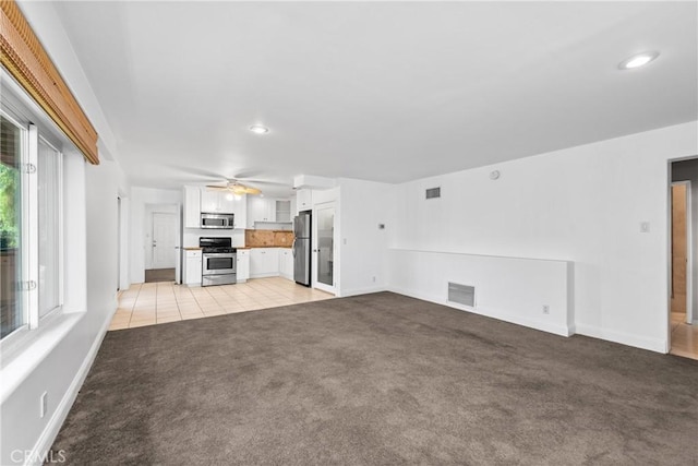 8462 Hillcroft Dr, West Hills, CA 91304 - unfurnished living room with light carpet, ceiling fan, recessed lighting, and light tile patterned floors