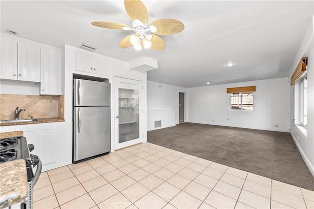 8462 Hillcroft Dr, West Hills, CA 91304 - kitchen featuring freestanding refrigerator, light carpet, gas range, white cabinetry, and a ceiling fan