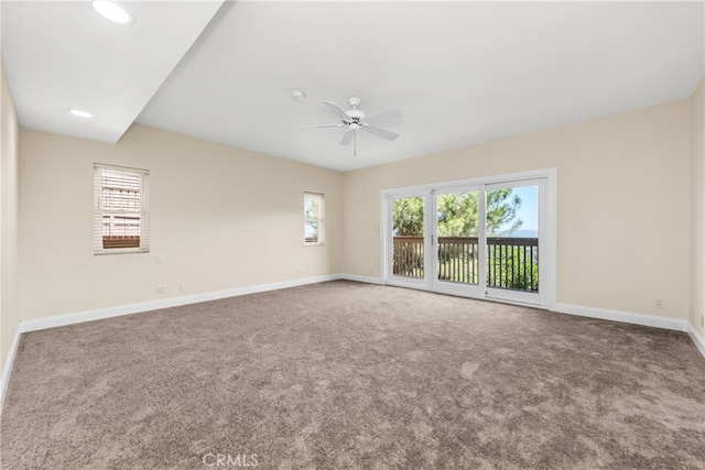 unfurnished room with ceiling fan, a healthy amount of sunlight, and carpet floors