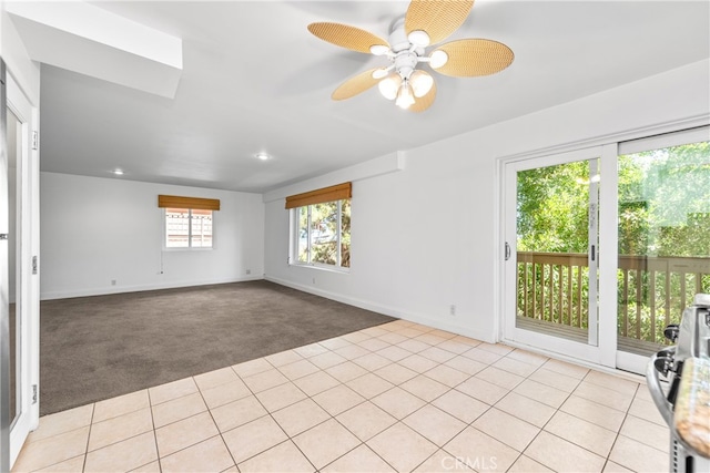 empty room featuring light carpet and ceiling fan