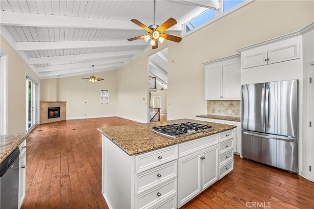 8462 Hillcroft Dr, West Hills, CA 91304 - kitchen featuring appliances with stainless steel finishes, a ceiling fan, hardwood / wood-style floors, backsplash, and light stone counters