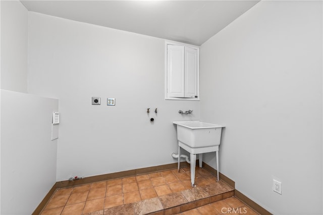 clothes washing area featuring washer hookup, hookup for an electric dryer, light tile patterned flooring, gas dryer hookup, and cabinets