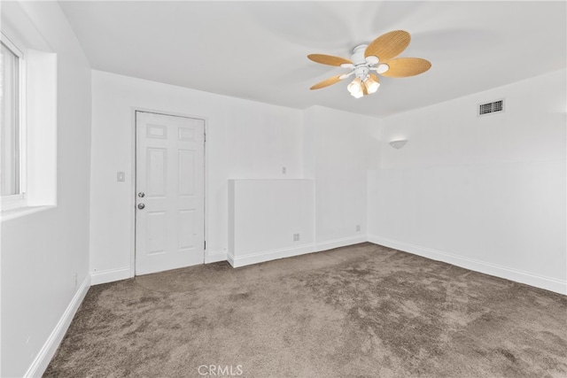 empty room with ceiling fan, carpet, and plenty of natural light