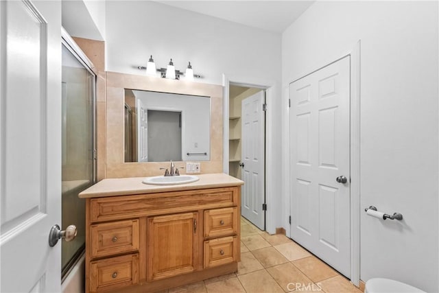 8462 Hillcroft Dr, West Hills, CA 91304 - full bath with vanity, tile patterned flooring, and combined bath / shower with glass door