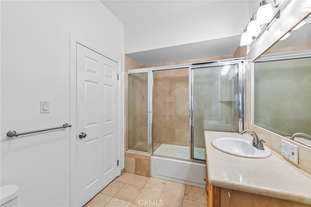 full bathroom with vanity, enclosed tub / shower combo, toilet, and tile patterned flooring