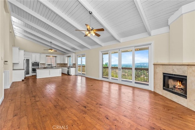 8462 Hillcroft Dr, West Hills, CA 91304 - unfurnished living room with ceiling fan, a fireplace, hardwood / wood-style flooring, high vaulted ceiling, and a wood ceiling with exposed beams