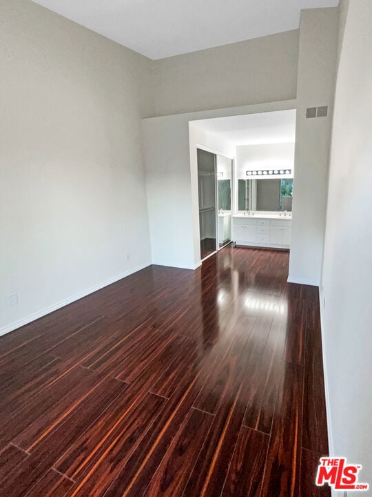 empty room with dark hardwood / wood-style flooring