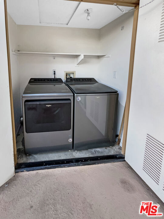 clothes washing area with separate washer and dryer