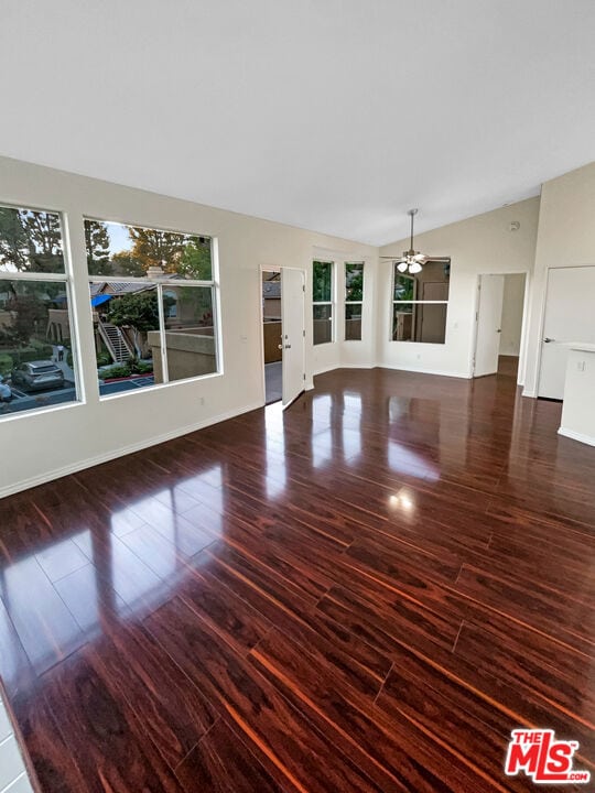 unfurnished living room with lofted ceiling and dark hardwood / wood-style flooring