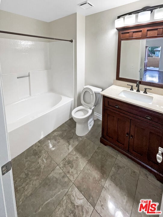 full bathroom with vanity, toilet, and shower / washtub combination