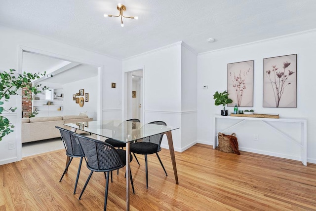 dining room with crown molding and light wood-type flooring