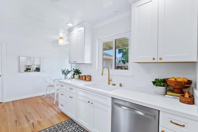 kitchen with sink, white cabinetry, light stone counters, stainless steel dishwasher, and light wood-type flooring