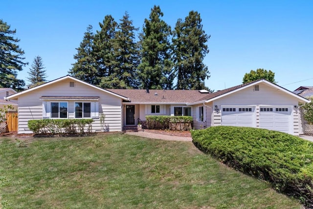 ranch-style house with a garage and a front lawn