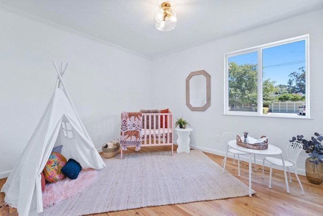 bedroom featuring wood-type flooring and crown molding