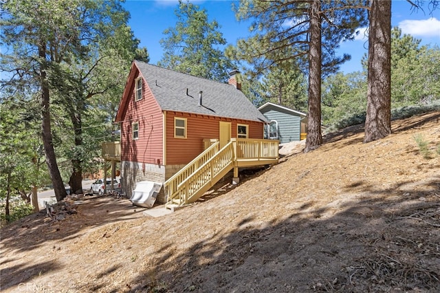 rear view of house with a wooden deck