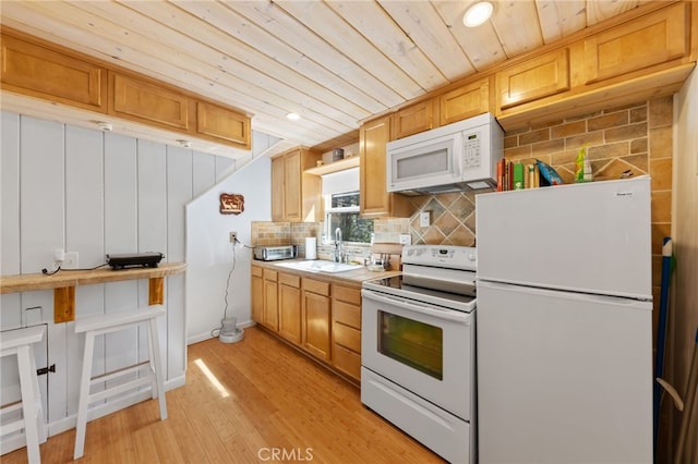 kitchen with wood ceiling, backsplash, light hardwood / wood-style flooring, tile counters, and white appliances