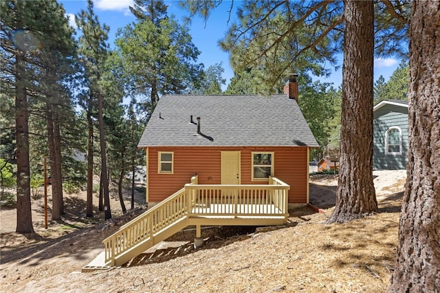 back of property featuring a wooden deck