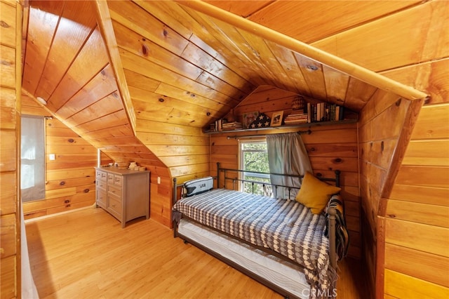 bedroom with wood ceiling, wooden walls, light wood-type flooring, and vaulted ceiling