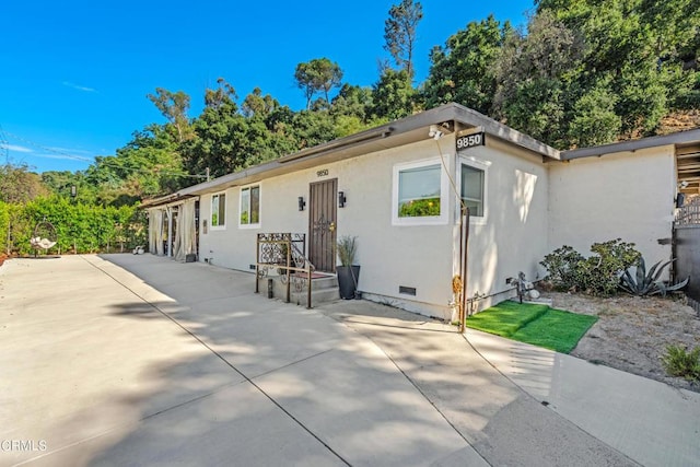 ranch-style home with a patio area