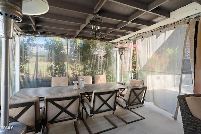 sunroom / solarium featuring coffered ceiling, plenty of natural light, and beamed ceiling