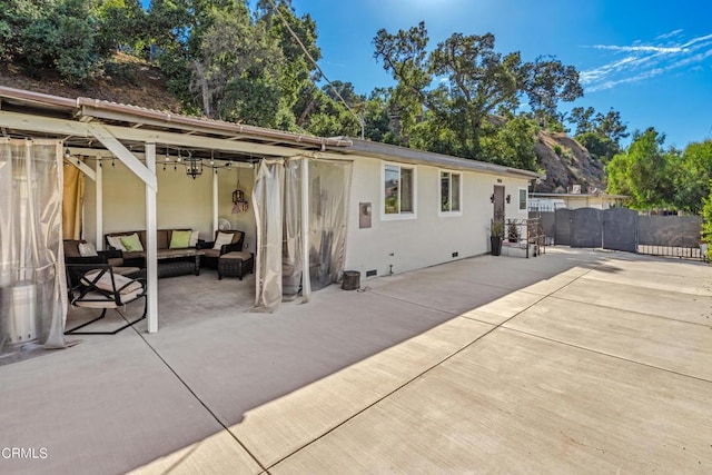 back of house with an outdoor hangout area and a patio area