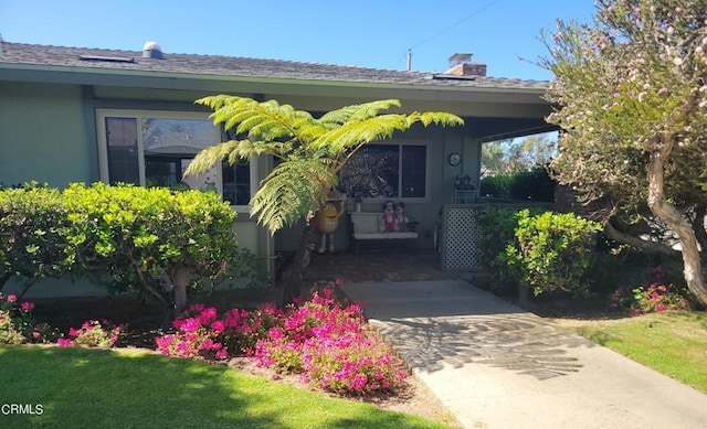 view of exterior entry with a yard