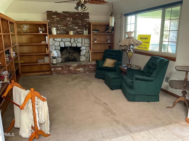 living area featuring a fireplace, carpet, and ceiling fan