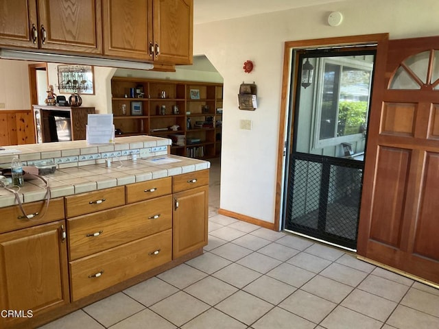 kitchen with tile counters and light tile patterned floors