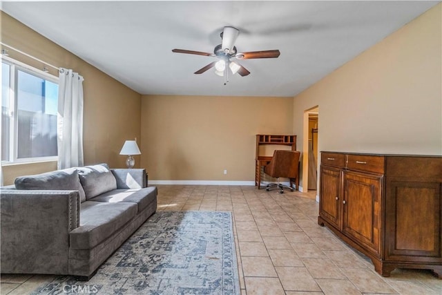 living area with ceiling fan and light tile patterned floors