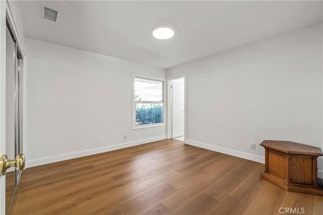 spare room with dark wood-type flooring