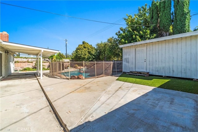 view of patio / terrace with a fenced in pool