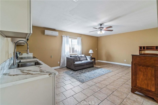 tiled living room with ceiling fan, sink, and a wall mounted air conditioner