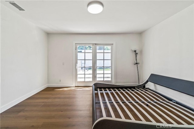 unfurnished bedroom with dark wood-type flooring