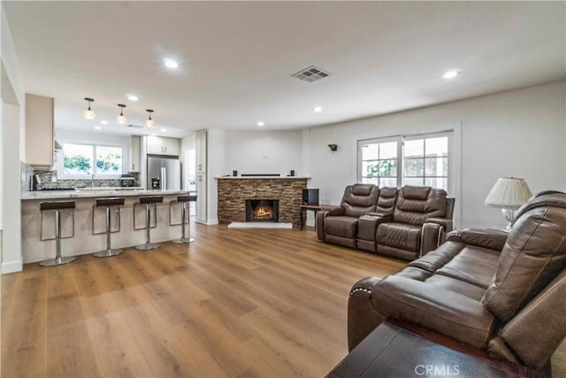 living room featuring a fireplace and light hardwood / wood-style flooring