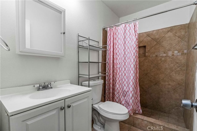 bathroom featuring curtained shower, vanity, and toilet