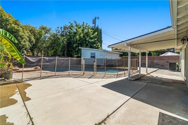 view of patio featuring a fenced in pool and central AC unit