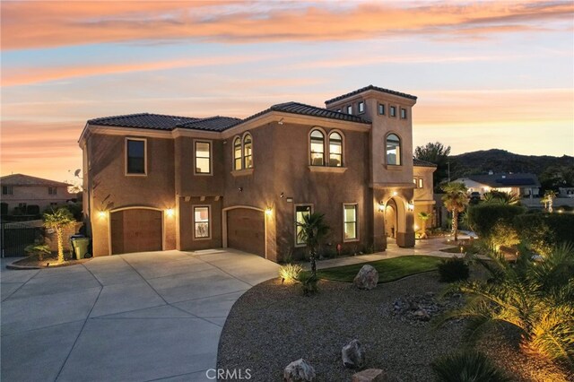 mediterranean / spanish-style home with a garage