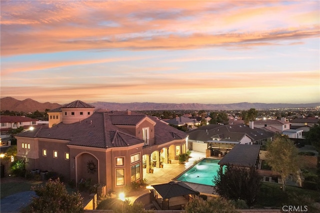 aerial view at dusk featuring a mountain view