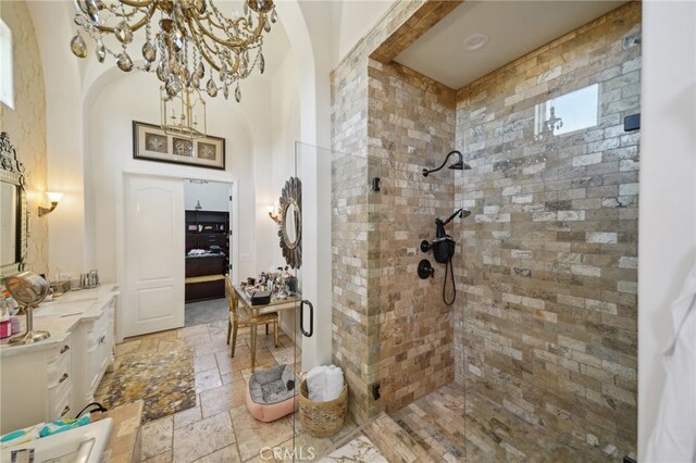 bathroom with vanity and tiled shower