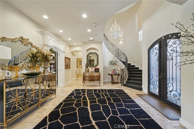 entryway with french doors and a towering ceiling