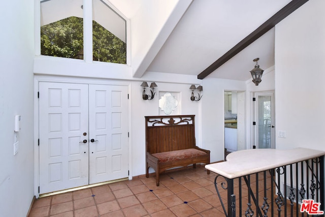 entryway featuring tile patterned flooring and lofted ceiling with beams