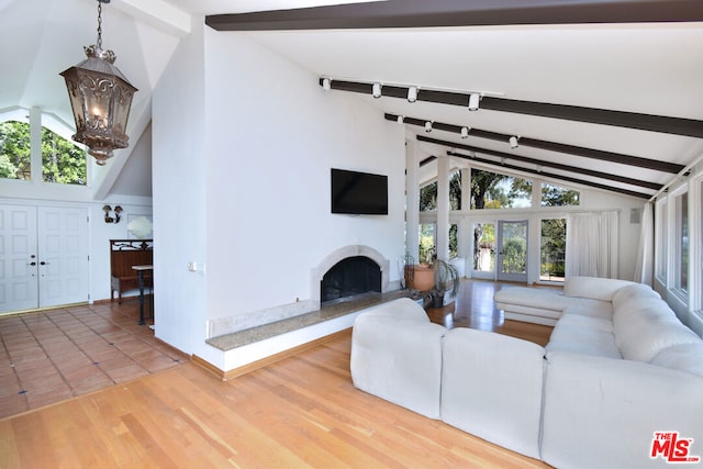 living room with high vaulted ceiling, french doors, an inviting chandelier, beamed ceiling, and wood-type flooring